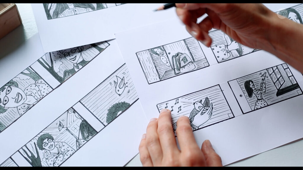 person using a pencil to draw old-fashioned and complex visual storyboards containing various cartoon scenes